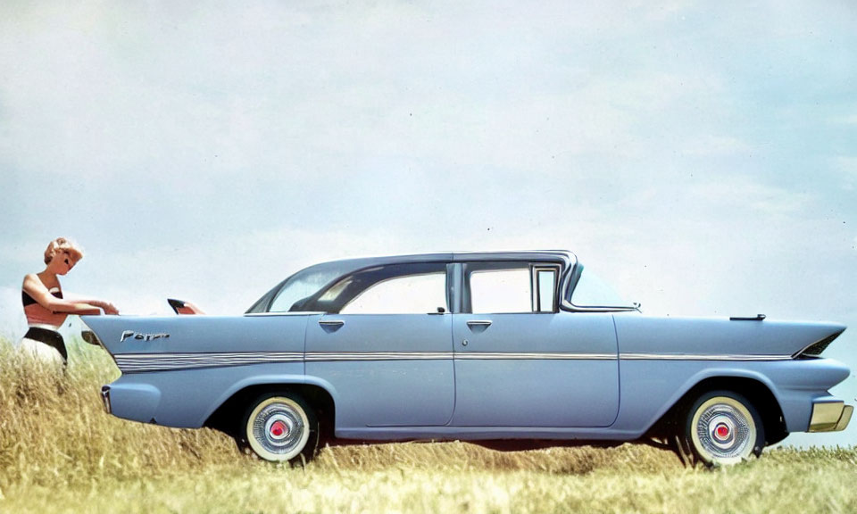 Vintage Blue Car Parked on Grass with Person by Open Trunk