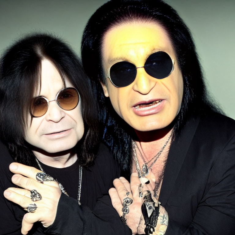 Two Men with Long Black Hair in Stylish Black Attire and Sunglasses