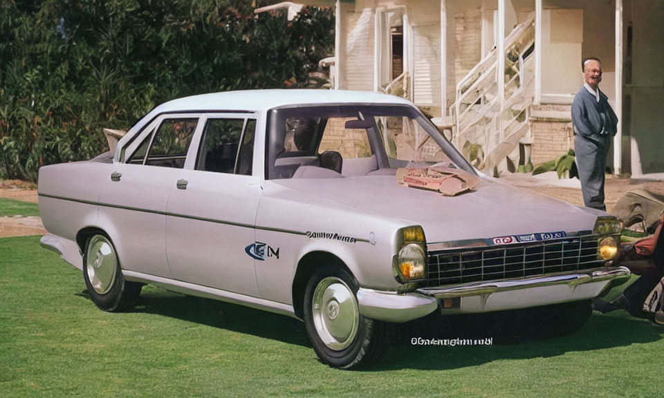 Vintage White Sedan Car Parked with Smiling Man on Lawn