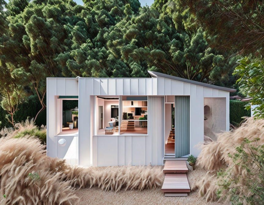 White-walled small house surrounded by trees and pampas grass