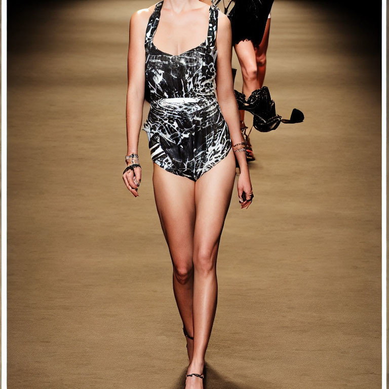 Person in Black and White Abstract Swimsuit Walking on Runway