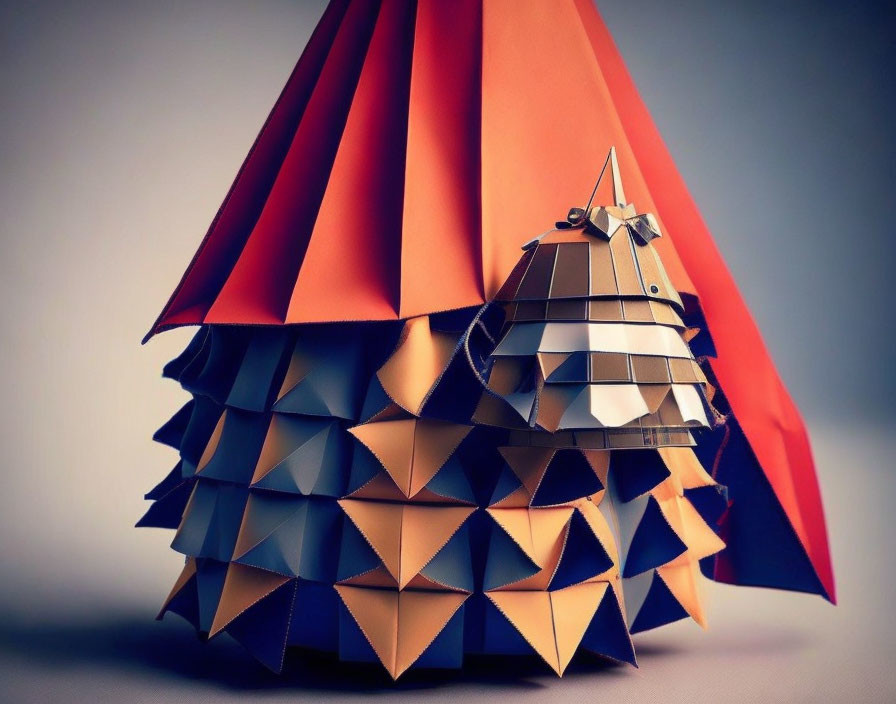 Christmas tree origami art in orange and navy blue paper with mirrored star topper