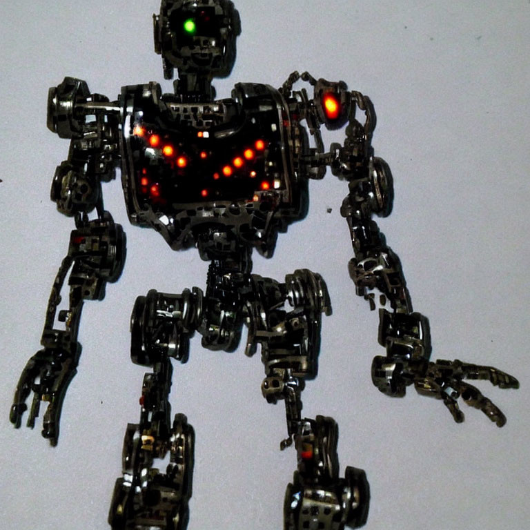 Articulated Metallic Robot Toy with Red LED Lights on Light Background