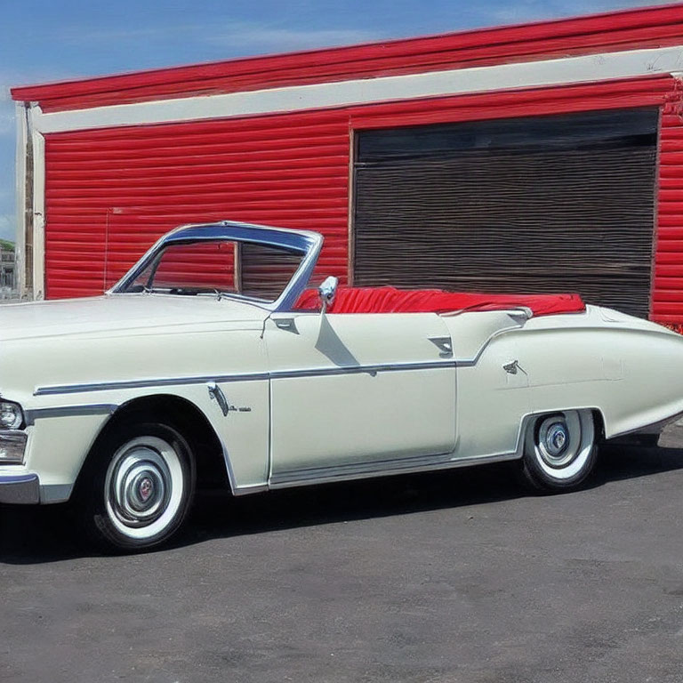 Classic White Convertible Car with Red Interior Parked by Red Storage Unit