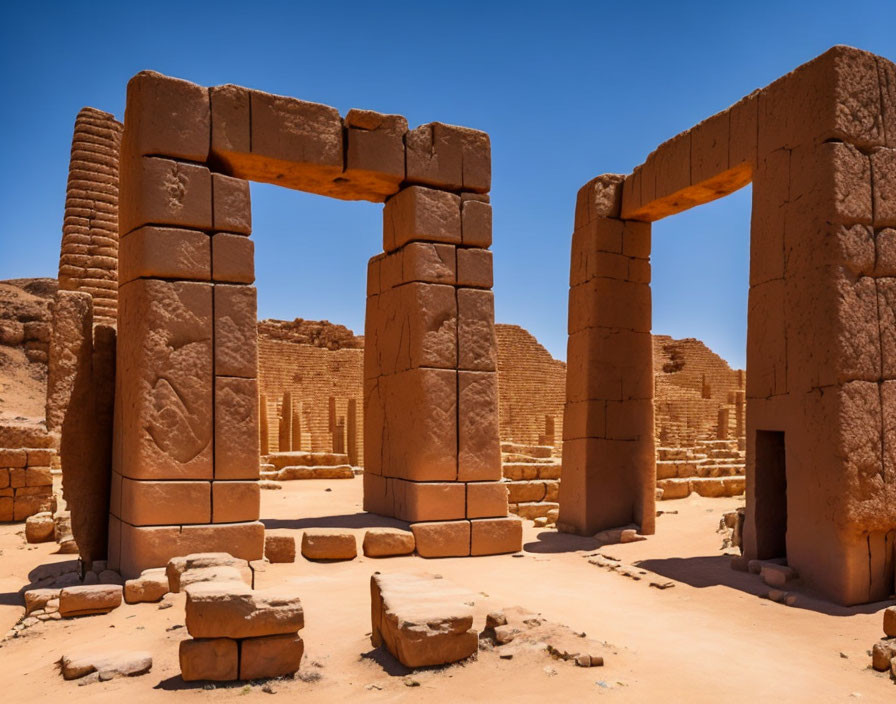 Ancient stone ruins with pillars and arches in desert landscape