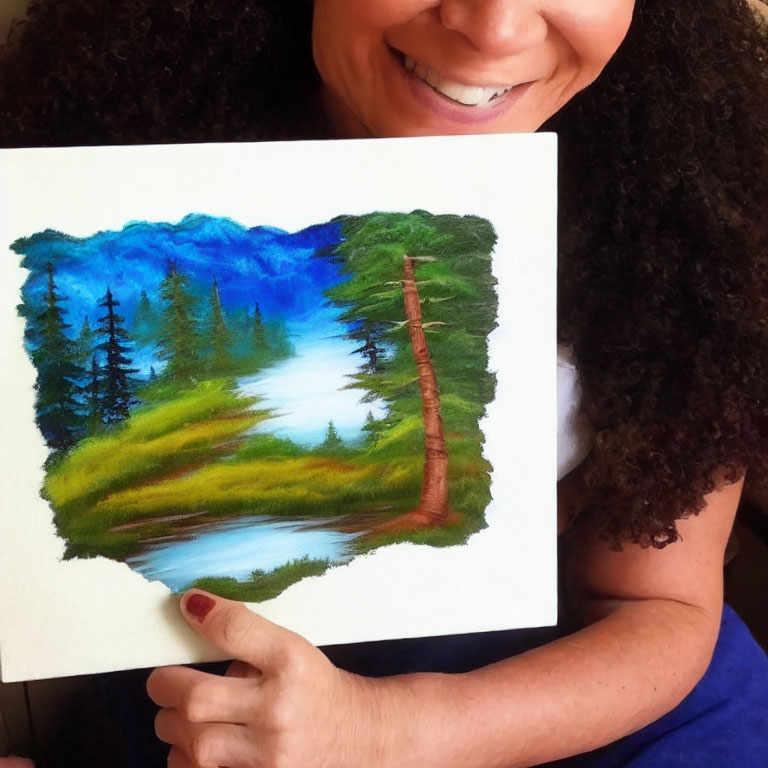 Smiling person holding vibrant landscape painting