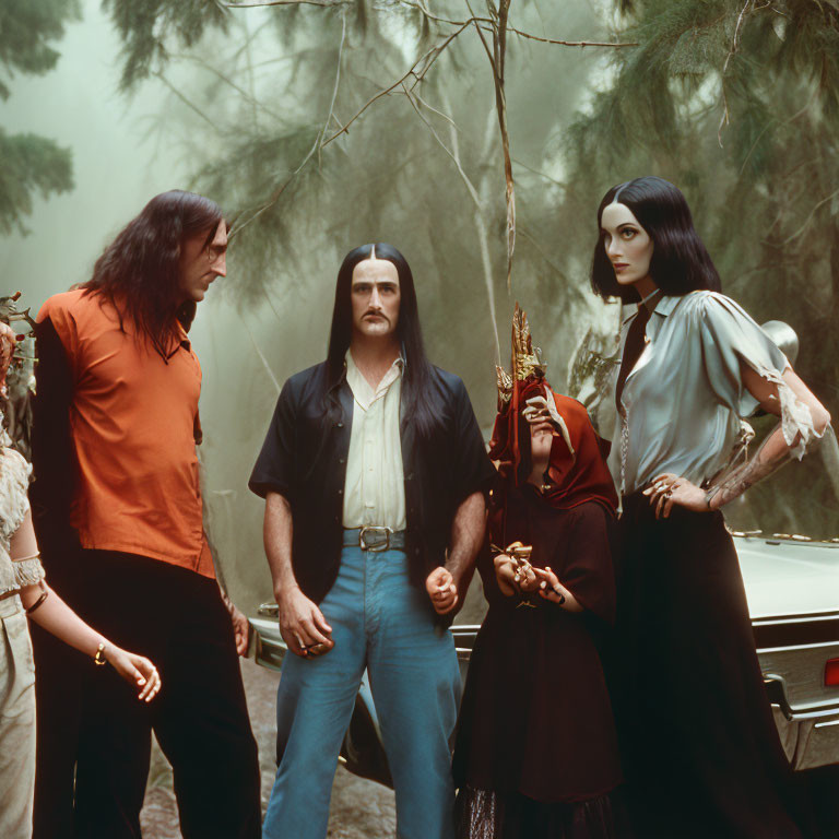 Gothic Attire Group in Foggy Forest with Vintage Car