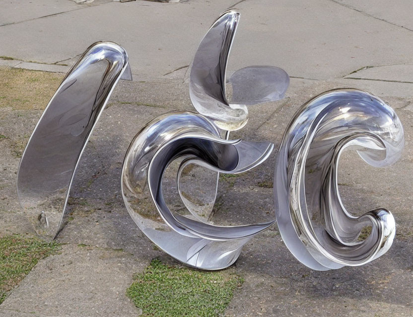 Abstract Swirling Metal Sculpture on Concrete with Grass Nearby