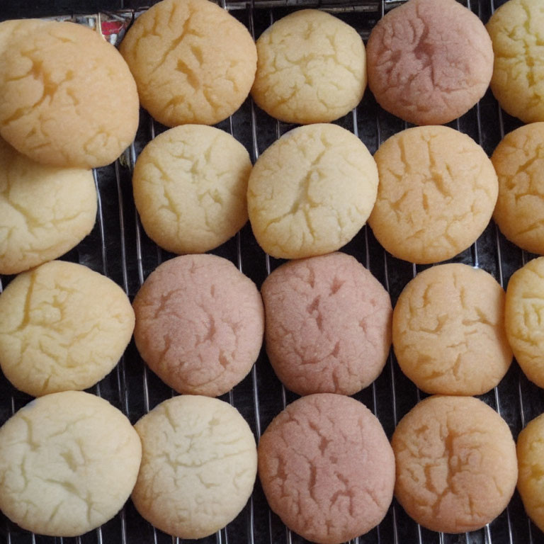 Round Cookies Cooling on Wire Rack with Golden Brown and Light Pink Hues