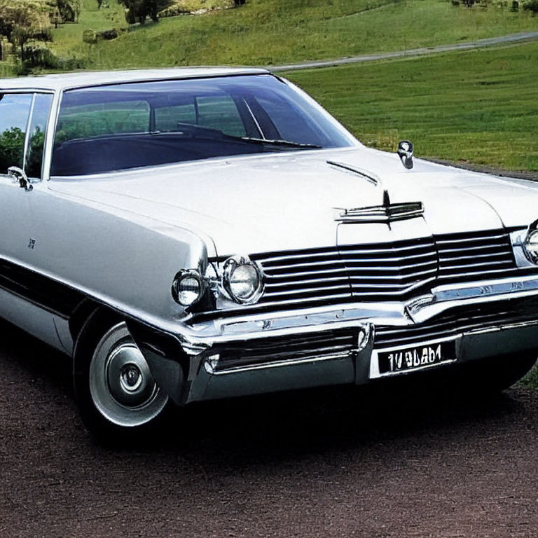 Classic Vintage White Car with Chrome Details on Grass Field