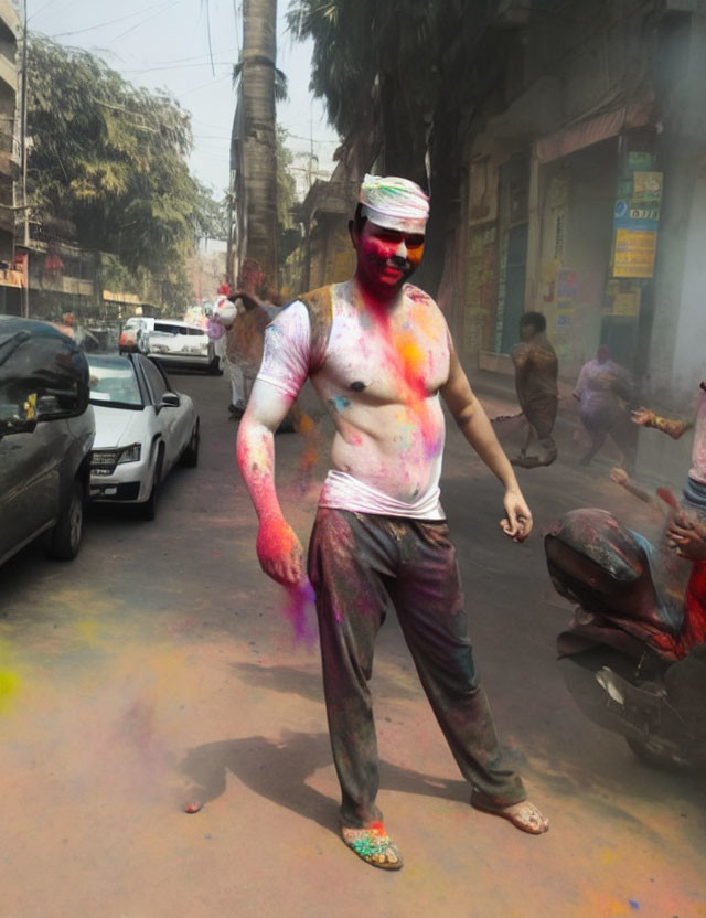 Vibrantly colored person at Holi celebration in street scene