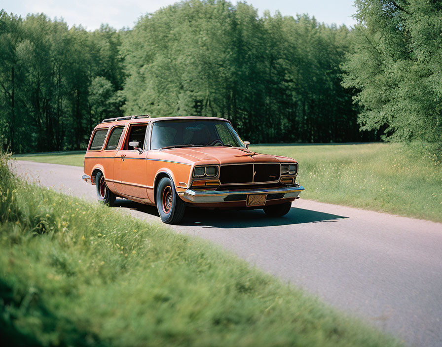 Classic Orange Station Wagon Driving Through Forest on Sunny Day