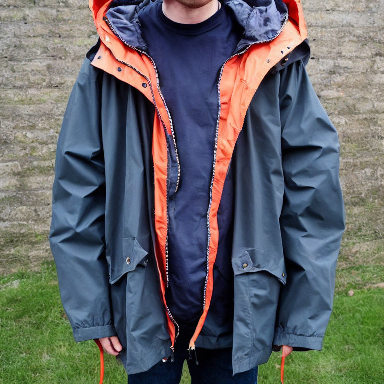 Person in Dark Blue T-Shirt and Grey Hooded Jacket Outdoors