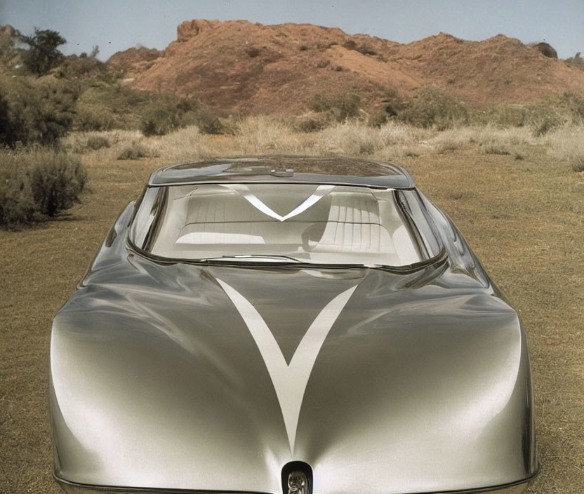 Sleek Silver Futuristic Car in Desert Landscape