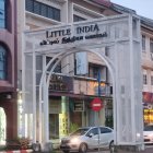 White Archway with Colorful Decorations and Vibrant Building Beyond