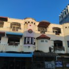 Multicolored whimsical architectural design with ornate balconies and surreal appearance