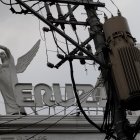 Monochrome artistic photo of mannequin-like figures with mechanical and abstract elements against geometric backdrop