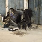 Black Motorcycle Parked in Front of Closed Garage Door with Brick Wall Background