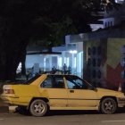 Dystopian-style yellow vehicle driving in barren landscape