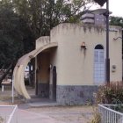 Modern White Curved House Among Trees with Round Windows and Doorway