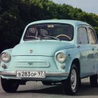 Turquoise Car with Artistic Details and Custom License Plate