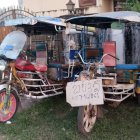 Vintage motorcycle with sidecar in white and orange at outdoor event