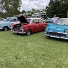 Vintage Cars in Disrepair Under Cloudy Sky