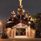 Intricately designed illuminated desert building with central fountain