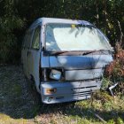 Vintage Caravan and Car with Man in Forest Setting