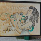 Vintage weathered billboard with illustrated woman promoting fair