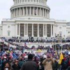 Crowd gathers in front of Capitol Building for event.