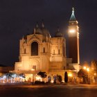 European Town Square Night View with Illuminated Buildings and People