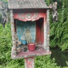 Rustic wooden hut with thatched roof in lush green forest