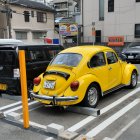 Classic Vintage Cars in Old Garage with Yellow Volkswagen Beetle