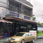 Gold Car Parked on Street with Quaint Two-Story Buildings