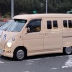 Vintage Beige Vans with Reflective Bubbles on Asphalt Road