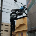 Flaming motorcycle with skull-helmeted rider in black outfit