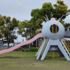 Colorful Inflatable Creature with Pink Tentacles and Blue Body in Park