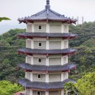 Beige multi-story building with cylindrical chimney and circular driveway