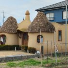 Cartoon-Style Cottage with Turquoise Roof in Lush Garden