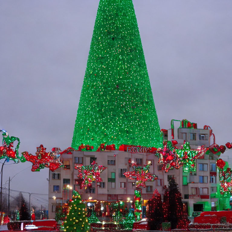 Festive large Christmas tree with lights in urban setting at dusk