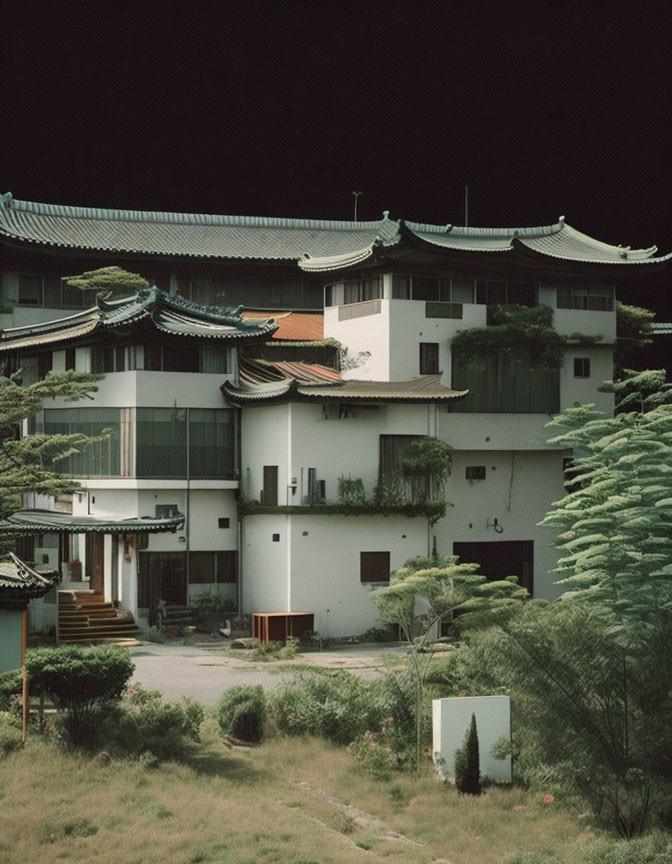 Curved rooflines on Traditional East Asian-style building in lush greenery