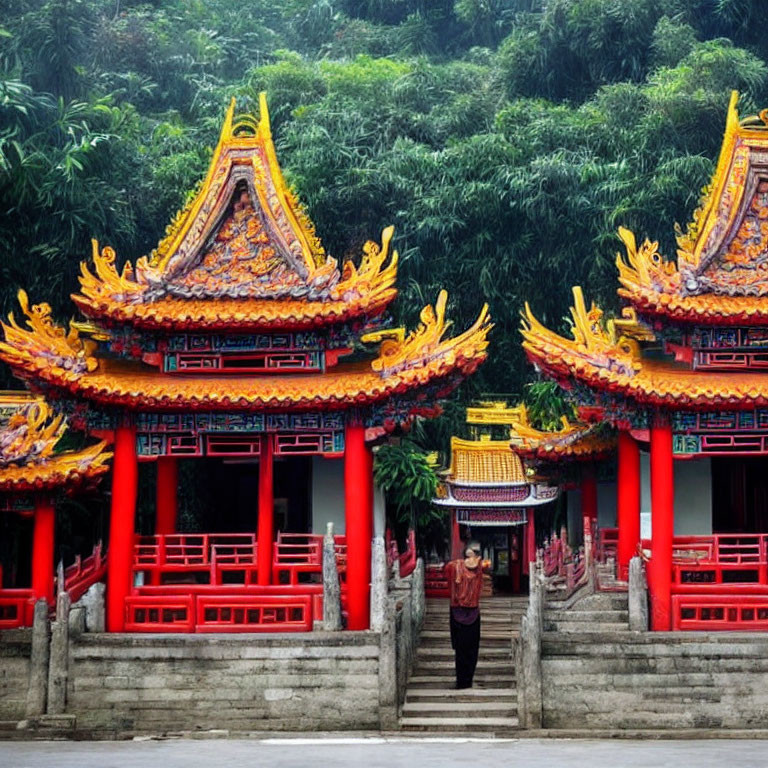 Traditional Chinese temples in vibrant red and yellow amidst lush greenery