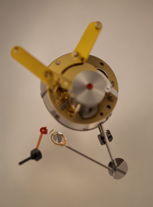 Detailed close-up of blurred clock hands and intricate gears in clock mechanism