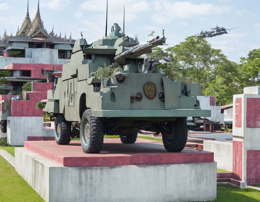 Armored military vehicle, helicopters, and traditional architecture under blue sky