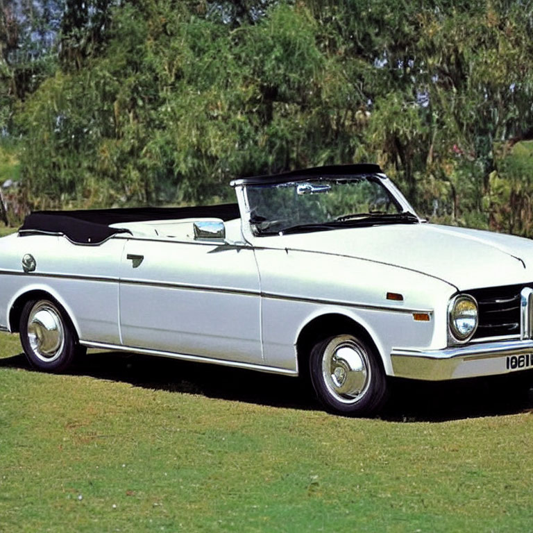 White Convertible Car Parked on Grass Under Clear Blue Sky