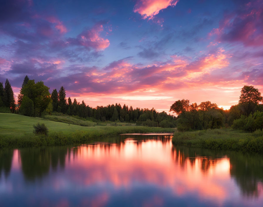 Tranquil sunset over calm lake with lush greenery