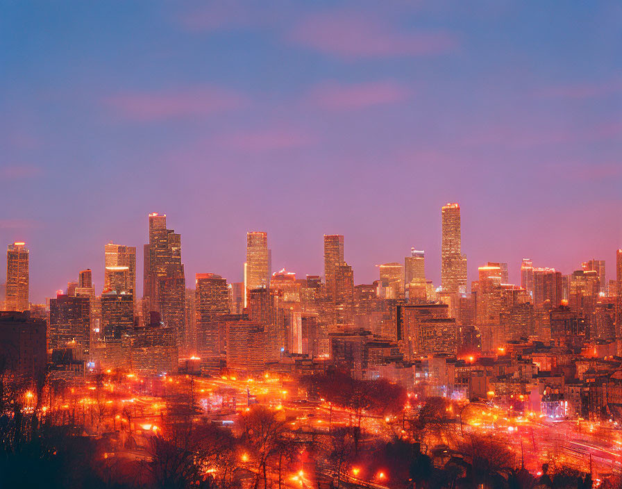 Cityscape at Twilight: Illuminated Skyscrapers and Traffic Streaks