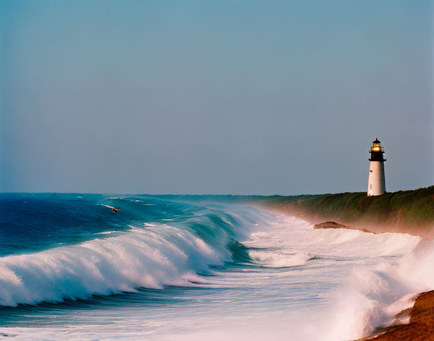 Coastal bluff lighthouse overlooking rolling ocean waves