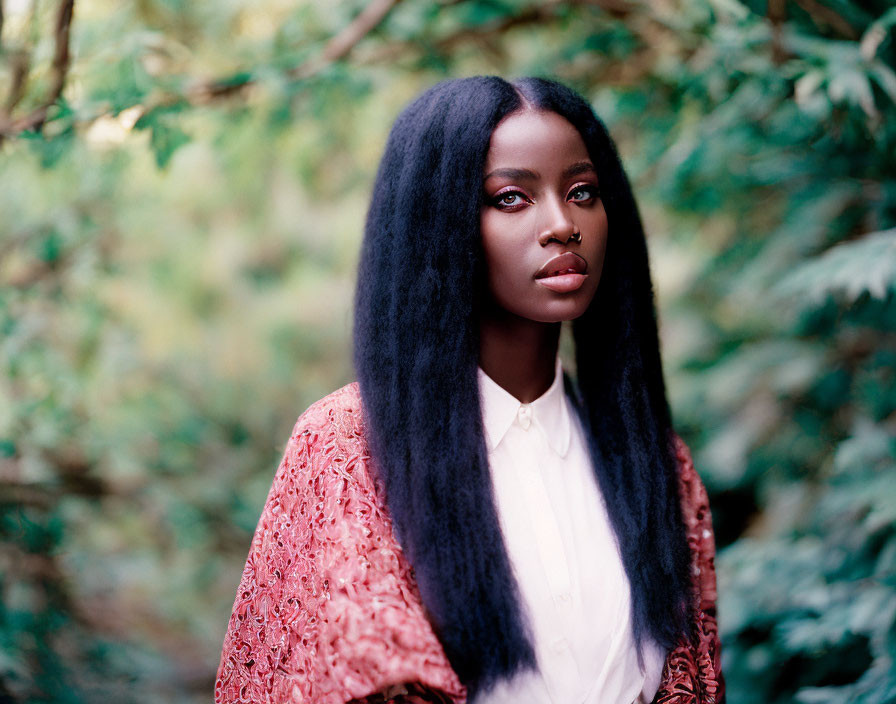 Woman with Long Black Hair and Nose Ring in White Blouse and Lace Garment Against Green Foli